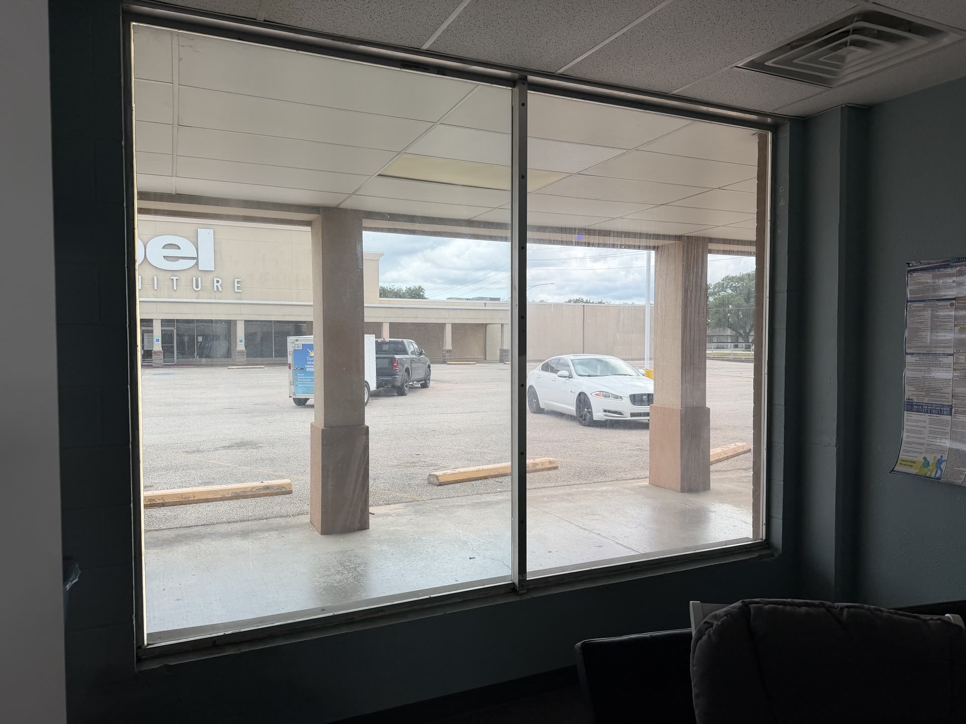 A tinted storefront window at Big Time Fitness in Clute