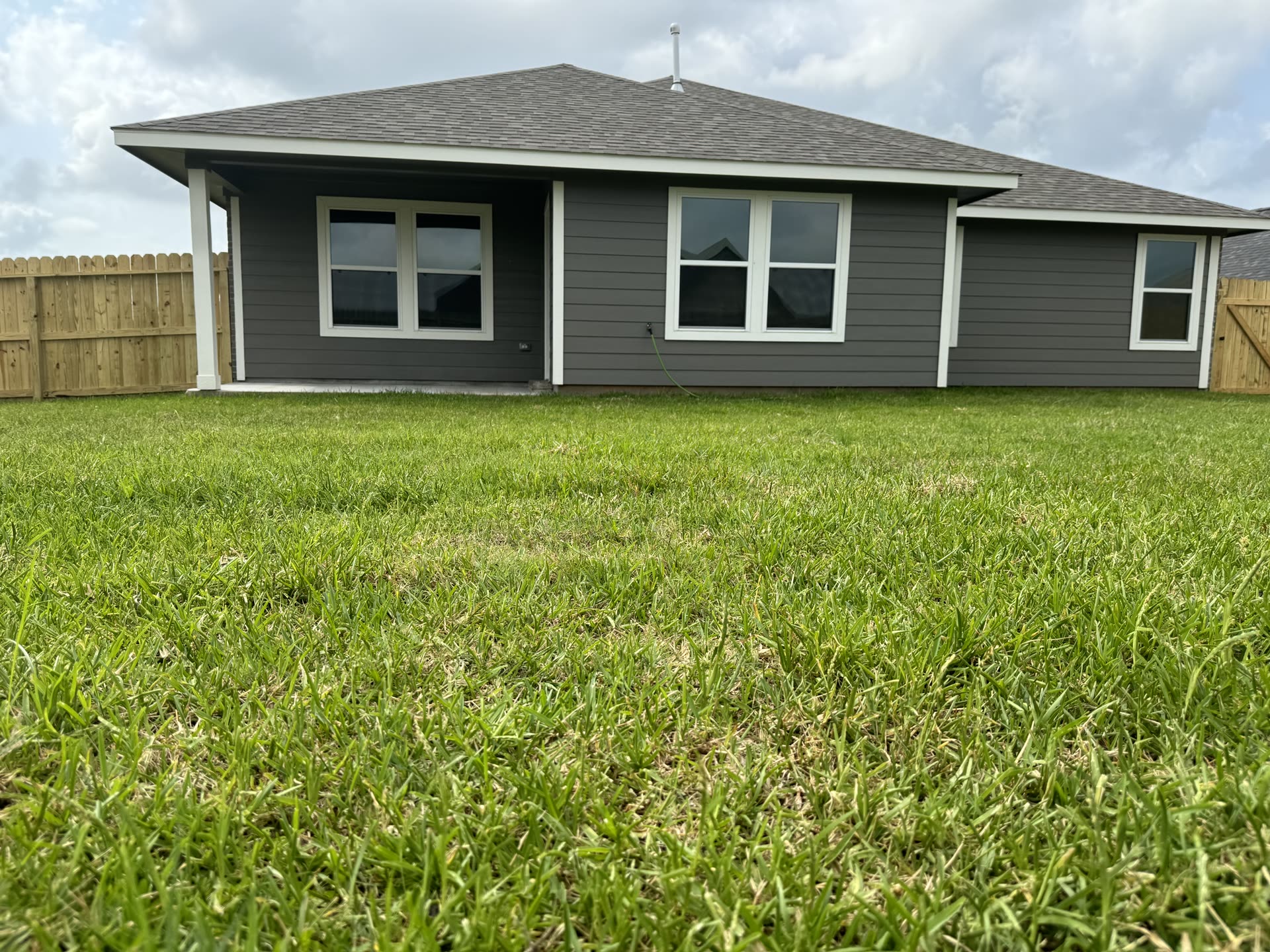 The back of a new home in Clute with tinted windows