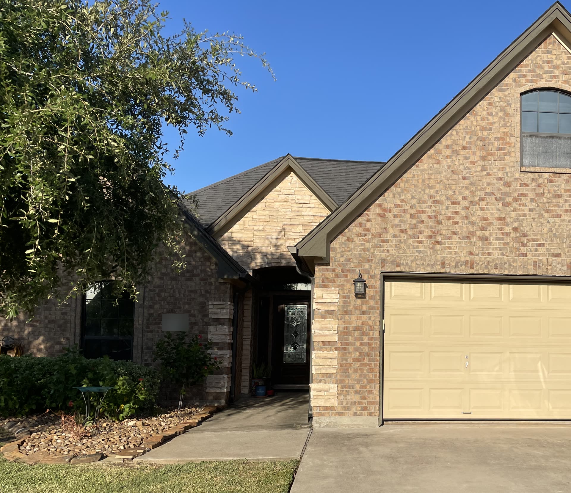 A brick home in Clute with tinted windows