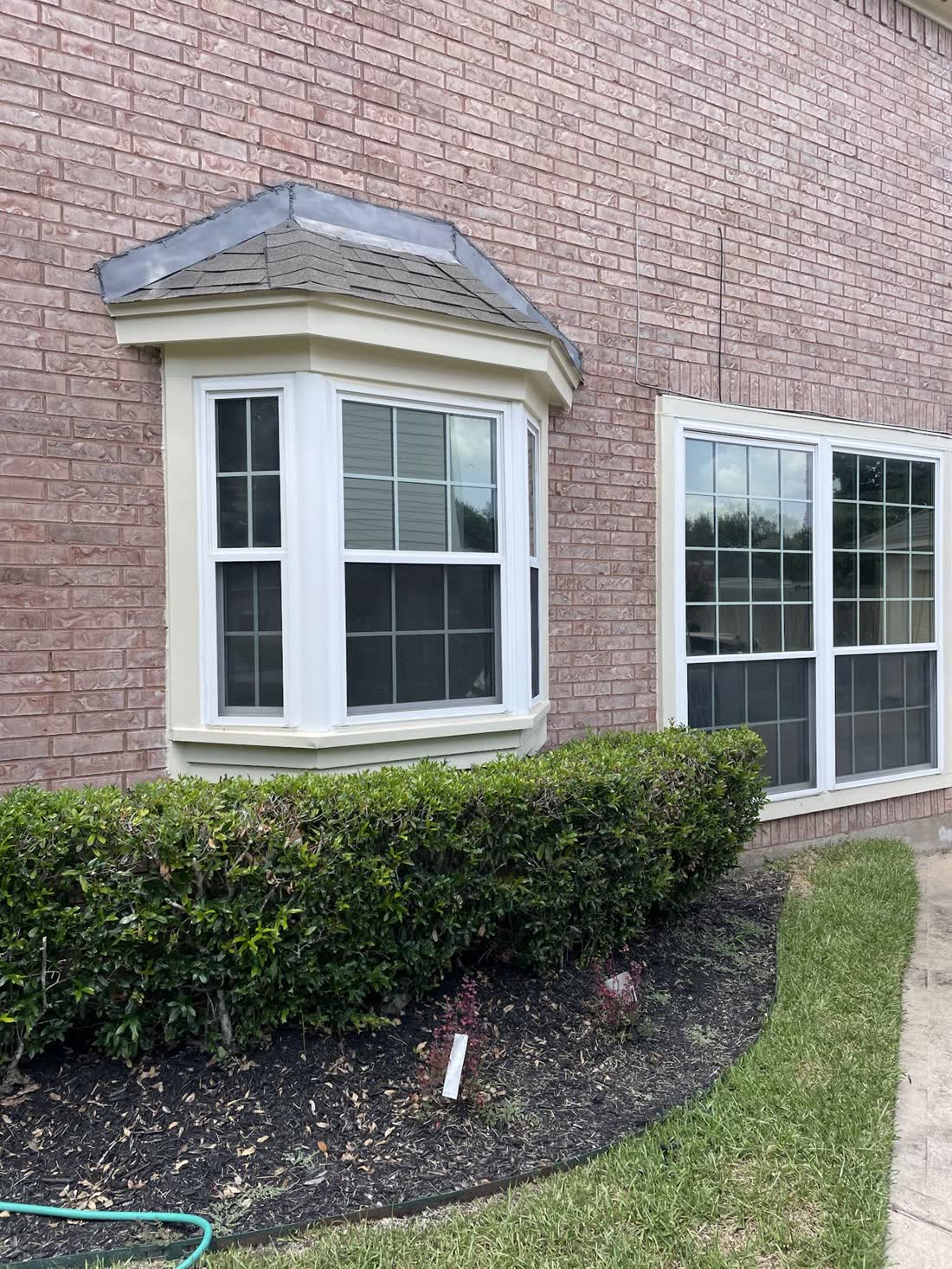 A bay window on a brick home after tinting