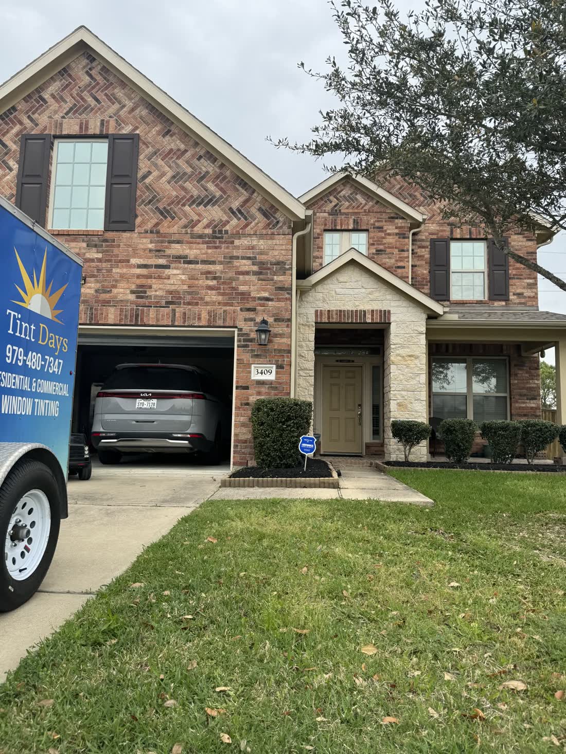 The Tint Days trailer outside a brick home in League City