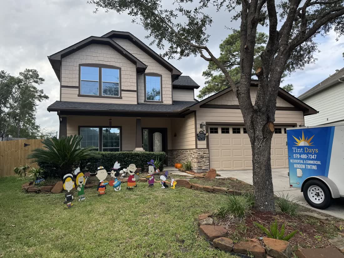 The Tint Days trailer in front of a two-story home in Pearland